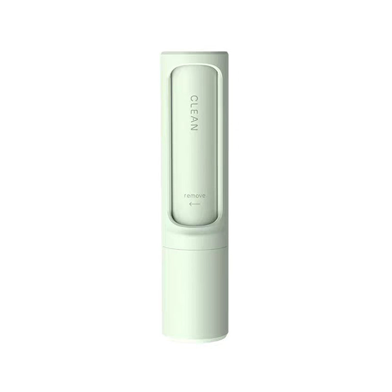 Single green reusable self-cleaning lint and pet hair remover roller on a white background.