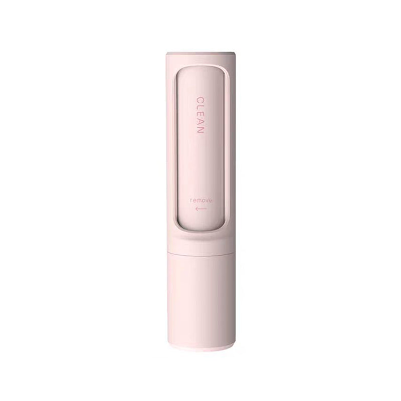 Single pink reusable self-cleaning lint and pet hair remover roller on a white background.
