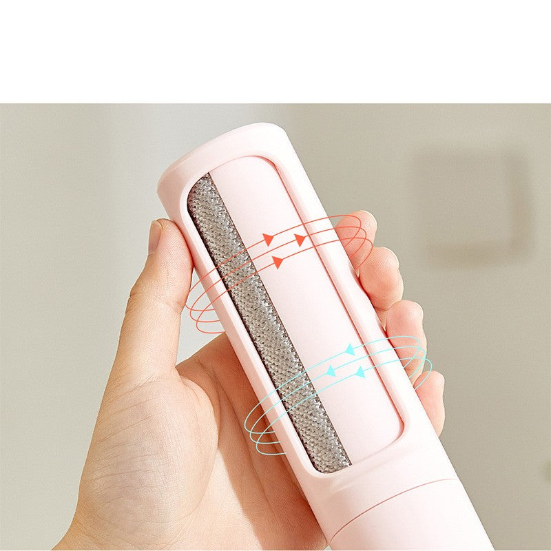 Close-up of a pink reusable lint remover roller showing its rotating self-cleaning mechanism.